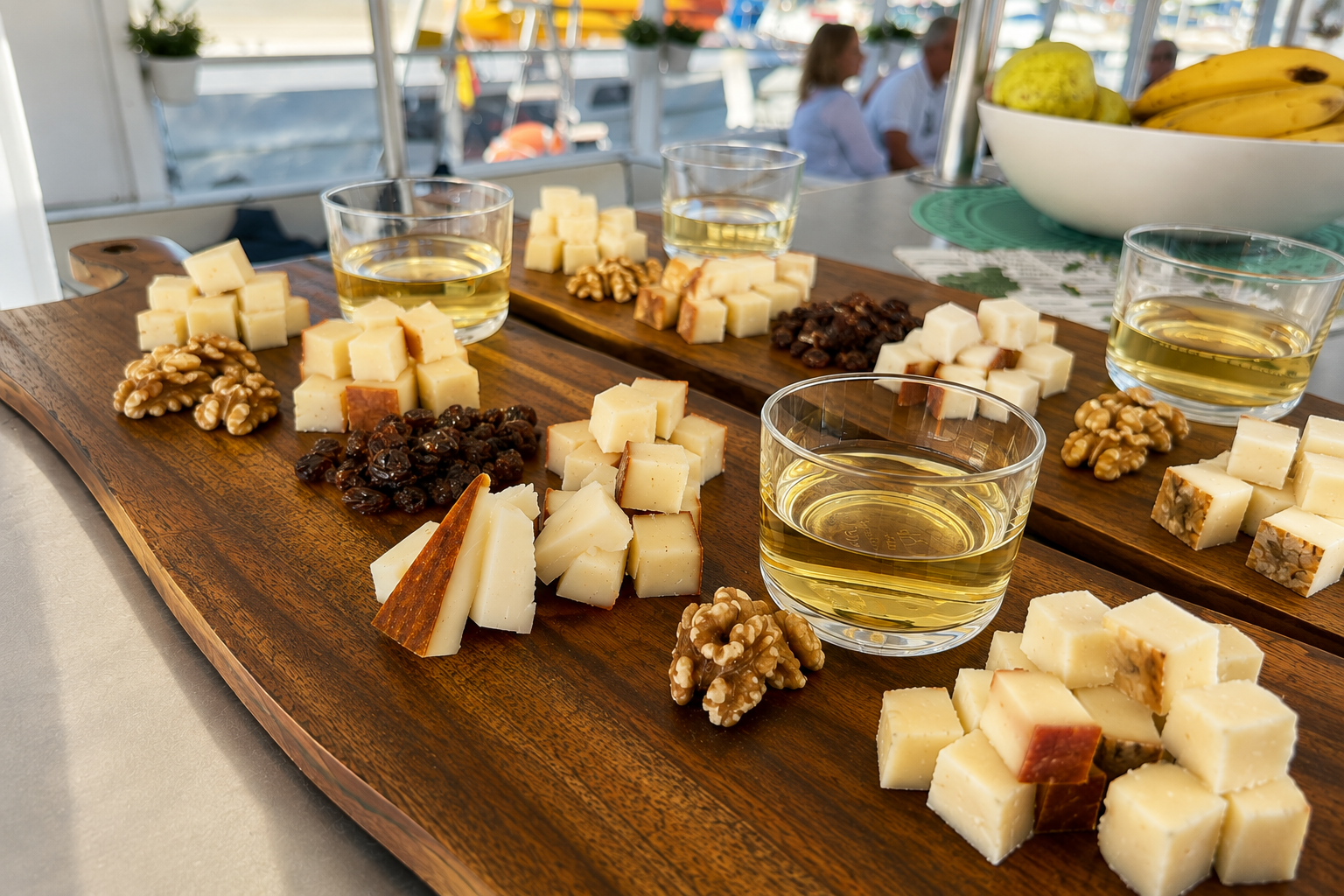 Canarian Cheese & Wine Tasting on Board Selection of Canarian cheeses, walnuts and raisins paired with local wine during a tasting experience on board in Puerto de Mogan, Gran Canaria.